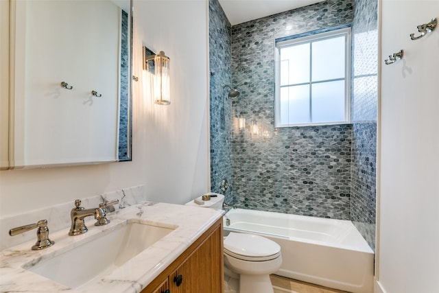 full bathroom with vanity, toilet, and tiled shower / bath combo