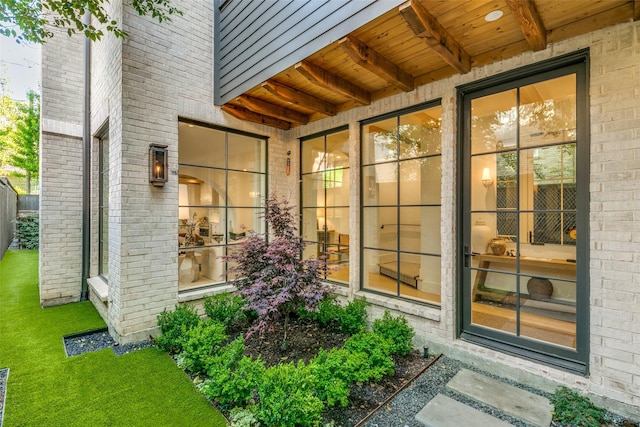 doorway to property with a yard