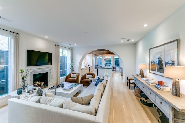 living room featuring light wood-type flooring and a fireplace