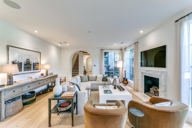 living room with light hardwood / wood-style flooring and a premium fireplace