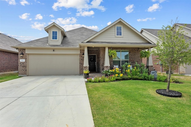 craftsman-style house with a garage, covered porch, and a front lawn