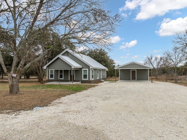 view of front of property featuring a carport and a porch