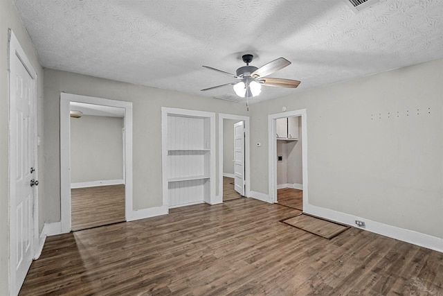 unfurnished bedroom featuring wood-type flooring, ceiling fan, a textured ceiling, and ensuite bath