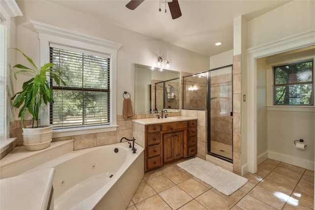 bathroom featuring tile patterned flooring, plus walk in shower, a wealth of natural light, and vanity