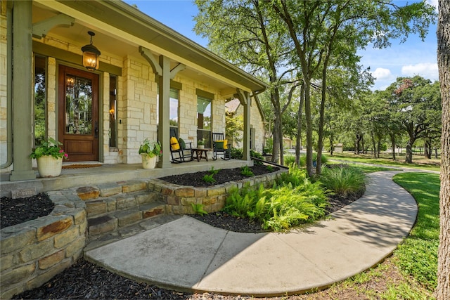 view of exterior entry with a porch