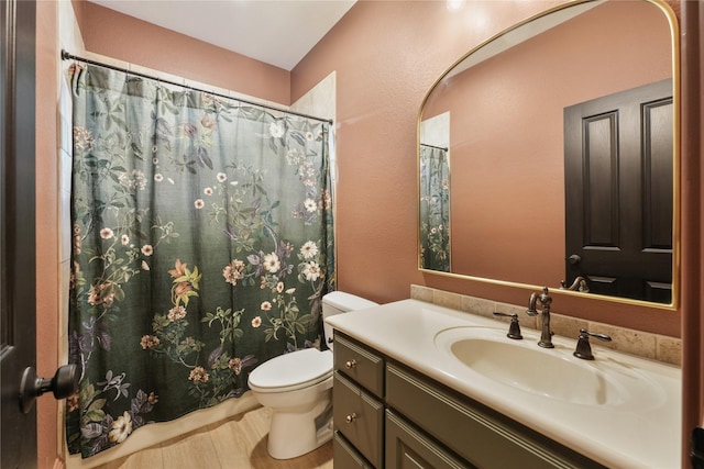 bathroom featuring hardwood / wood-style flooring, vanity, toilet, and a shower with curtain