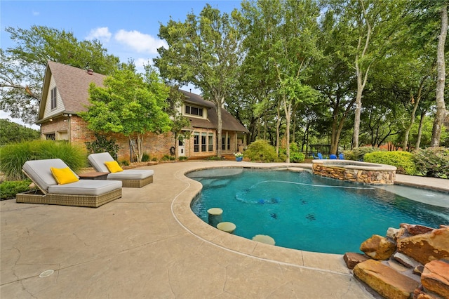 view of swimming pool with a patio area and an in ground hot tub