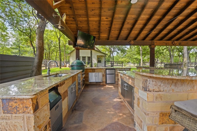 view of patio featuring area for grilling and sink