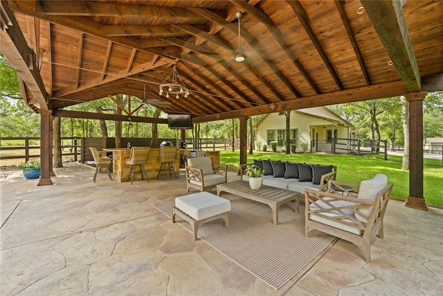 view of patio / terrace with a gazebo, an outdoor living space, and exterior bar