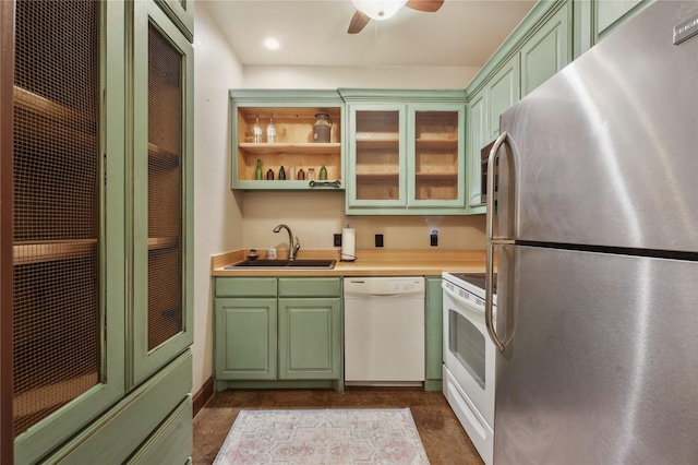 kitchen featuring ceiling fan, white appliances, and sink