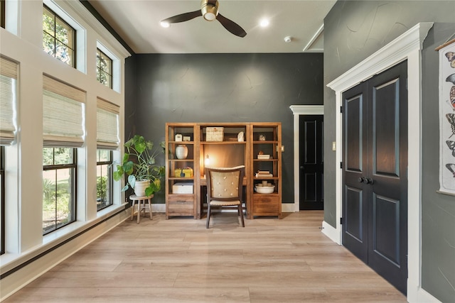 living area featuring ceiling fan and light hardwood / wood-style flooring