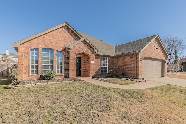 view of property featuring a garage and a front yard