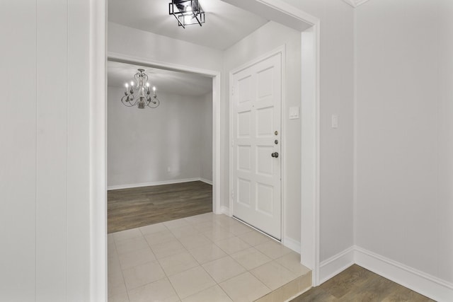 entryway featuring hardwood / wood-style flooring and a chandelier