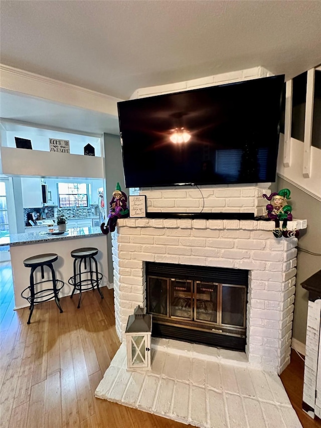 details featuring hardwood / wood-style flooring and a fireplace