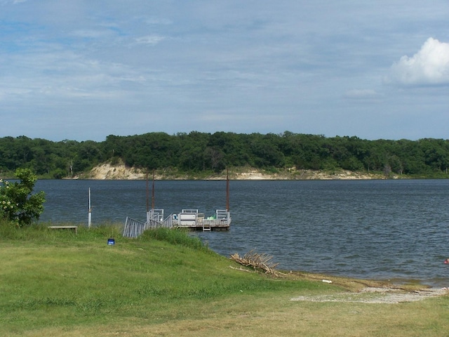 dock area featuring a water view and a wooded view