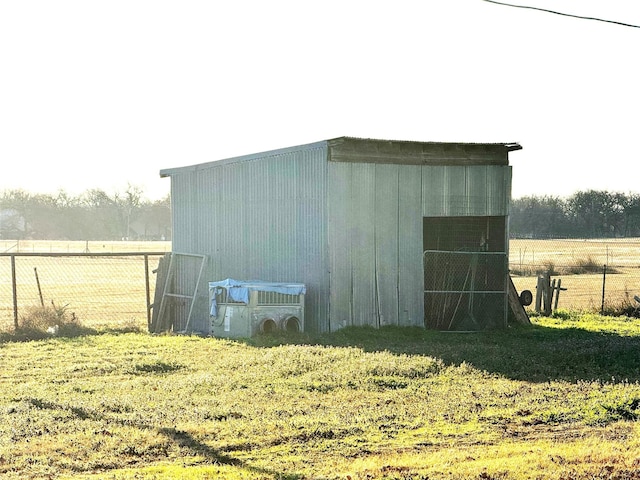 view of outbuilding with central air condition unit and a lawn