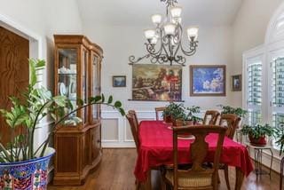 dining room with an inviting chandelier and dark hardwood / wood-style floors