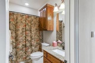 bathroom with vanity, toilet, and walk in shower