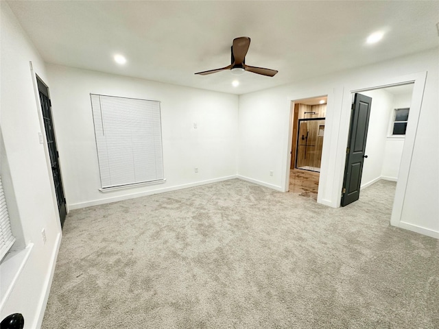 unfurnished bedroom with light carpet, ceiling fan, and ensuite bath