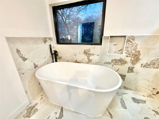 bathroom with tile walls and a bath