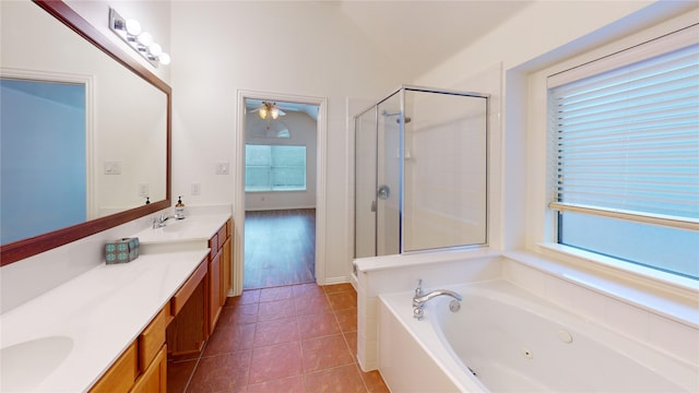 bathroom featuring tile patterned floors, plus walk in shower, and vanity