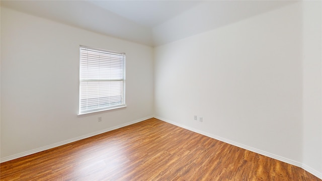 unfurnished room with wood-type flooring