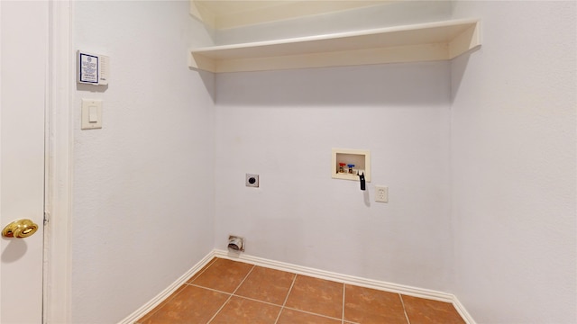 laundry area featuring hookup for a washing machine, dark tile patterned floors, and hookup for an electric dryer