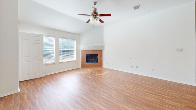 unfurnished living room featuring ceiling fan, wood-type flooring, a fireplace, and lofted ceiling