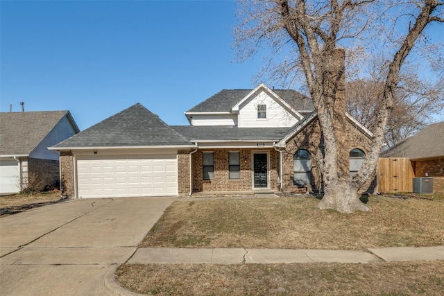 front of property featuring cooling unit, a garage, and a front yard