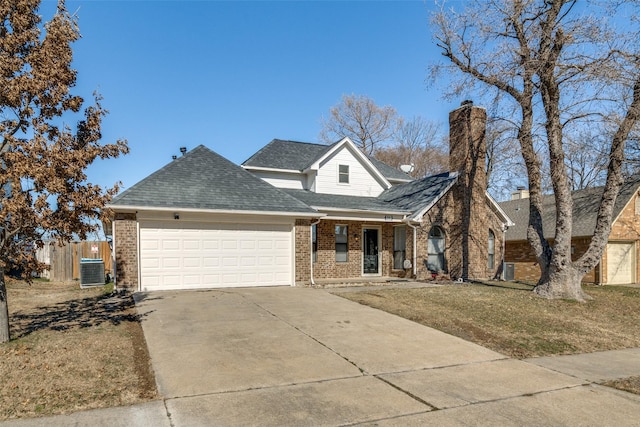 view of property featuring a garage, central AC, and a front lawn