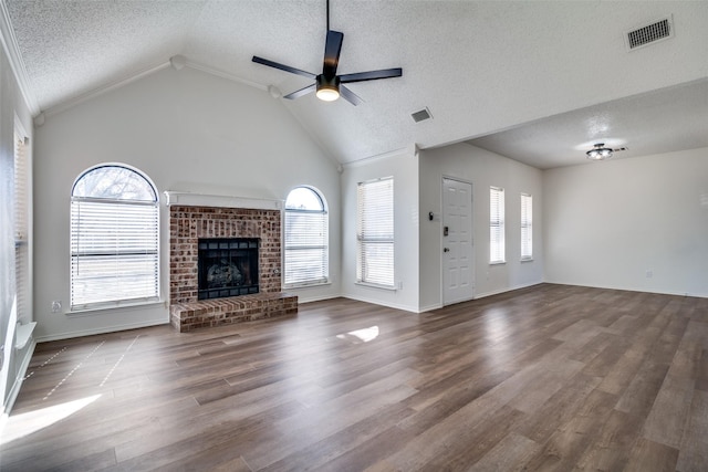 unfurnished living room featuring a wealth of natural light, a fireplace, and wood-type flooring