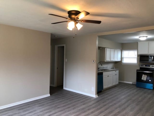 kitchen with sink, white cabinetry, dark hardwood / wood-style flooring, black dishwasher, and range with electric cooktop