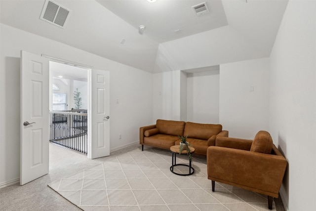 carpeted living room featuring vaulted ceiling