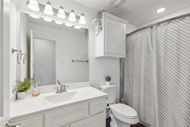 bathroom featuring vanity, a shower with shower curtain, and toilet