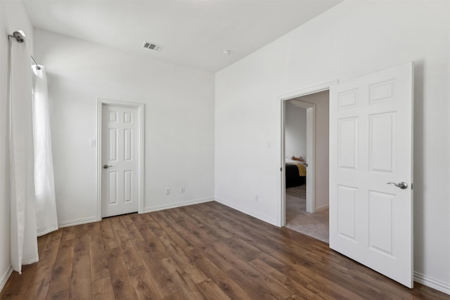 empty room featuring dark hardwood / wood-style flooring