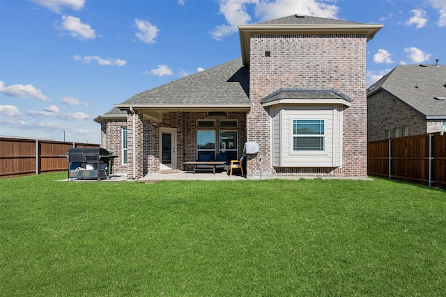 back of property with a patio area and a lawn