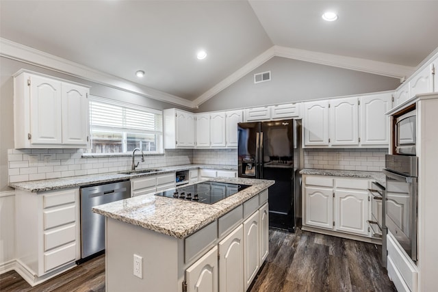 kitchen with white cabinetry, sink, black appliances, and a kitchen island