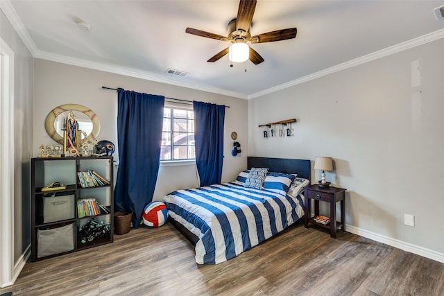 bedroom featuring hardwood / wood-style flooring, ornamental molding, and ceiling fan