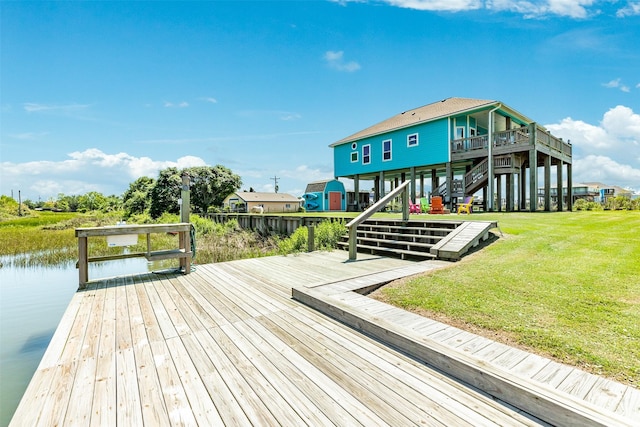 dock area featuring a water view and a yard