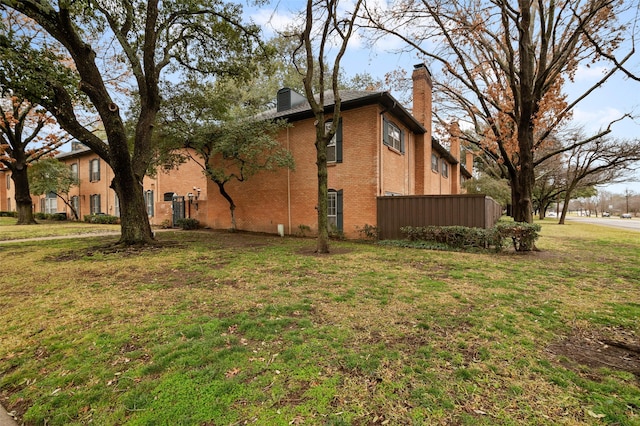 view of side of property with a lawn