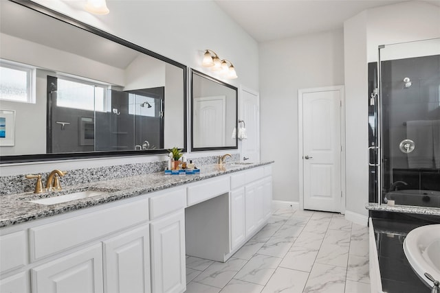 bathroom with vanity and a shower with door