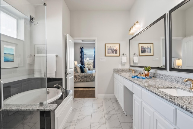 bathroom with vanity, a wealth of natural light, and a washtub