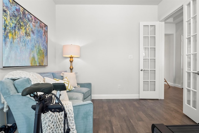 living area with dark hardwood / wood-style floors and french doors