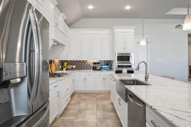 kitchen featuring pendant lighting, white cabinetry, sink, backsplash, and stainless steel appliances