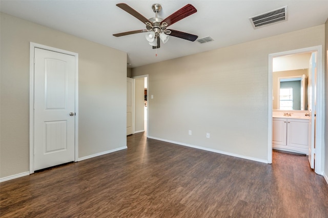 unfurnished bedroom with dark wood-type flooring and ceiling fan