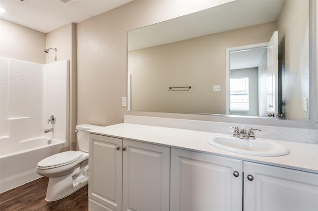 full bathroom with hardwood / wood-style flooring, vanity, toilet, and shower / bathing tub combination