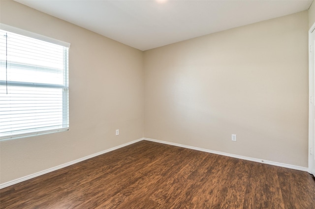 spare room with dark hardwood / wood-style floors