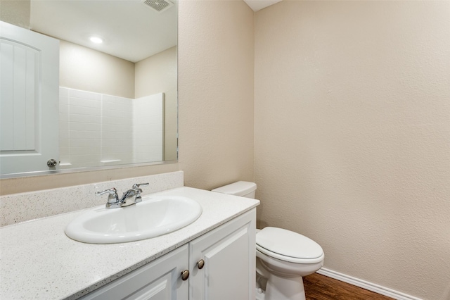 bathroom featuring vanity, toilet, and wood-type flooring