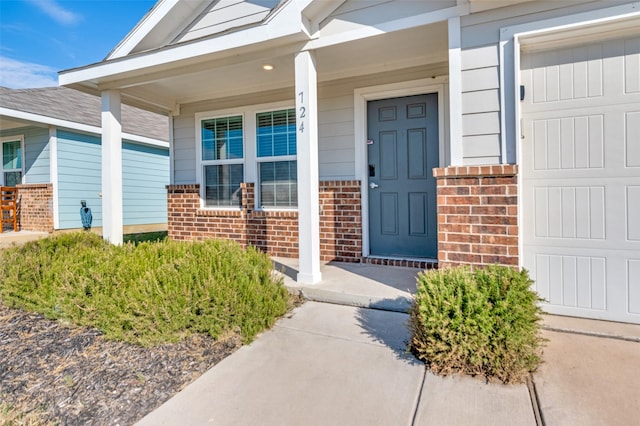 view of exterior entry with a porch