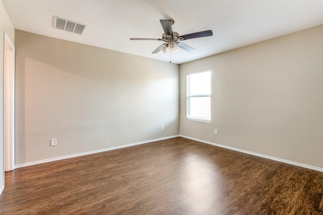 empty room with dark wood-type flooring and ceiling fan